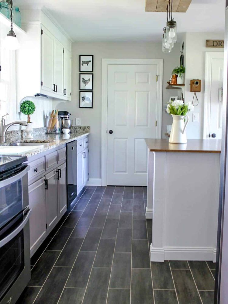 Finished interior hallway with white trim, built-in cabinetry, and wood floors