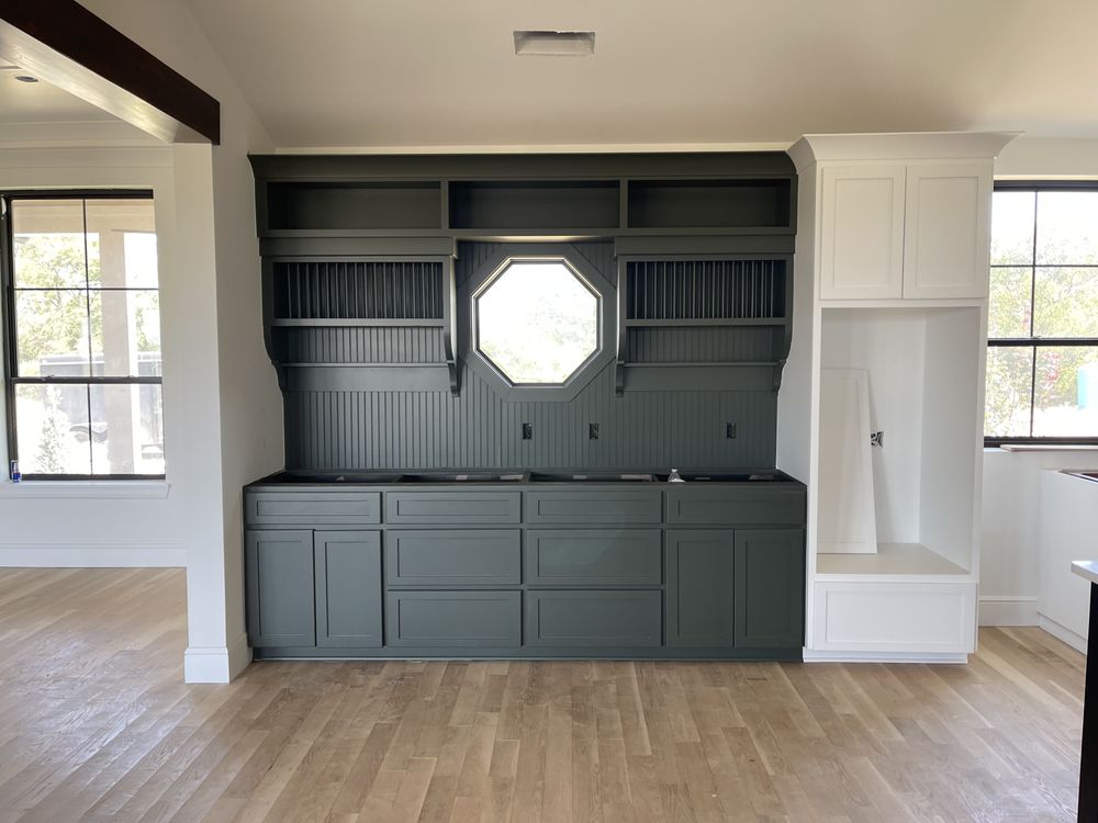 Living room with gray built-ins around a stone fireplace